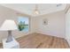 Bright bedroom featuring wood flooring, a ceiling fan, and a window with a beautiful lake view at 1157 Rotonda Cir, Rotonda West, FL 33947