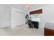 Bright bedroom features neutral carpet, ceiling fan, and built-in shelves, perfect for a home office at 1157 Rotonda Cir, Rotonda West, FL 33947