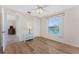 Cozy bedroom showcasing wood floors, a ceiling fan, and a picturesque lake view from the window at 1157 Rotonda Cir, Rotonda West, FL 33947