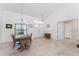 Open-concept dining area with high ceilings and a view of the entryway at 1157 Rotonda Cir, Rotonda West, FL 33947