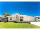 Charming single-story home with a well-manicured lawn and an attached two-car garage at 1157 Rotonda Cir, Rotonda West, FL 33947