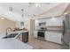 Bright kitchen featuring stainless steel appliances, a speckled countertop, and tile flooring at 1157 Rotonda Cir, Rotonda West, FL 33947