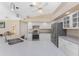 Bright kitchen with white cabinetry, stainless steel appliances, and speckled countertops at 1157 Rotonda Cir, Rotonda West, FL 33947