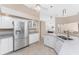Bright kitchen with white cabinets, stainless steel appliances, and an eat-in breakfast bar at 1157 Rotonda Cir, Rotonda West, FL 33947
