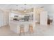 Bright kitchen features granite countertops, stainless steel appliances, and eat-in island at 1157 Rotonda Cir, Rotonda West, FL 33947