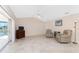 Spacious living room with sliding doors opening to screened lanai and water views at 1157 Rotonda Cir, Rotonda West, FL 33947