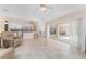 Open floor plan living room with adjacent kitchen and access to the screened patio at 1157 Rotonda Cir, Rotonda West, FL 33947