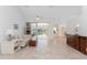 Bright living room featuring tile flooring and seamless access to the lanai at 1157 Rotonda Cir, Rotonda West, FL 33947