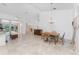 Inviting living space featuring tile flooring, chandelier, and sliding glass doors to the pool area at 1157 Rotonda Cir, Rotonda West, FL 33947