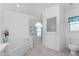 Bright ensuite bathroom with a soaking tub, step-in shower and private toilet room at 1157 Rotonda Cir, Rotonda West, FL 33947