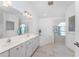 Bright ensuite bathroom with a double vanity, tub, and step-in shower at 1157 Rotonda Cir, Rotonda West, FL 33947