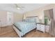 Comfortable main bedroom featuring a decorative quilt and wood floors and bright natural light at 1157 Rotonda Cir, Rotonda West, FL 33947