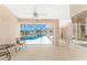 A covered lanai featuring comfortable seating and a view of the screened pool at 1157 Rotonda Cir, Rotonda West, FL 33947
