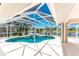 Enclosed screened-in pool area featuring a pool and a jacuzzi with lots of outdoor space at 1157 Rotonda Cir, Rotonda West, FL 33947
