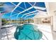 Screened-in pool and hot tub with clear blue water and canal views at 1157 Rotonda Cir, Rotonda West, FL 33947