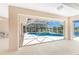 View of a screened-in pool and spa overlooking a serene lake, accessible from the patio at 1157 Rotonda Cir, Rotonda West, FL 33947