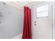 Shower with gray tile and a red curtain at 1157 Rotonda Cir, Rotonda West, FL 33947