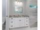 Bathroom featuring a granite countertop vanity, white cabinets, drawers, and mosaic tiled walls at 13344 Gershwin Ln, Port Charlotte, FL 33981
