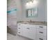 Bathroom with a granite countertop vanity, white cabinets and drawers, and mosaic tiled walls at 13344 Gershwin Ln, Port Charlotte, FL 33981