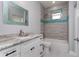 Stylish bathroom featuring a granite countertop, white cabinets, and tiled shower with a window at 13344 Gershwin Ln, Port Charlotte, FL 33981