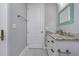 Bright bathroom features white vanity, tile floor, and a door to the left at 13344 Gershwin Ln, Port Charlotte, FL 33981