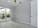 Bright bedroom features tile floors and a sliding glass door to the patio at 13344 Gershwin Ln, Port Charlotte, FL 33981