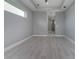 A spacious room with light tile flooring, bright natural light, and neutral gray walls at 13344 Gershwin Ln, Port Charlotte, FL 33981