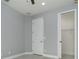Bright bedroom with gray walls, white trim, closet and white door at 13344 Gershwin Ln, Port Charlotte, FL 33981
