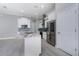 A modern kitchen featuring white cabinets, stainless steel appliances, and an island with granite countertops at 13344 Gershwin Ln, Port Charlotte, FL 33981