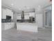 A beautifully designed kitchen features white cabinetry, stainless steel appliances and plenty of countertop space at 13344 Gershwin Ln, Port Charlotte, FL 33981