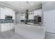 Modern kitchen featuring white cabinetry, stainless steel appliances, and a center island with a marble countertop at 13344 Gershwin Ln, Port Charlotte, FL 33981