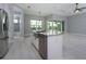 Spacious open kitchen with granite countertops, island sink, and stainless steel appliances overlooking living area at 13344 Gershwin Ln, Port Charlotte, FL 33981