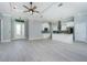 Bright, open floor plan featuring stainless steel appliances, a modern kitchen with a center island, and tile flooring at 13344 Gershwin Ln, Port Charlotte, FL 33981