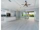 Open concept living space featuring tile flooring, and sliding glass doors leading to a screened-in pool area at 13344 Gershwin Ln, Port Charlotte, FL 33981