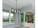 Light-filled living space featuring sliding doors to a screened-in pool area and modern pendant lighting at 13344 Gershwin Ln, Port Charlotte, FL 33981