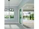 Bright living area showcases sliding glass doors to a screened-in pool area, and contemporary light fixtures at 13344 Gershwin Ln, Port Charlotte, FL 33981