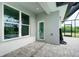 View of the patio with tile floors and door leading inside at 13344 Gershwin Ln, Port Charlotte, FL 33981