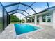 Screened-in pool features a large deck and lush landscaping at 13344 Gershwin Ln, Port Charlotte, FL 33981