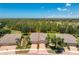 Expansive home in a lush community with manicured landscaping and views of a golf course at 13392 Abercrombie Dr, Englewood, FL 34223