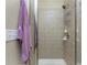 Bathroom shower with glass door and tiled walls at 13392 Abercrombie Dr, Englewood, FL 34223