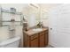Neutral bathroom with a single sink vanity, a large mirror, updated fixtures and plenty of storage at 13392 Abercrombie Dr, Englewood, FL 34223