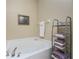Clean bathroom featuring a soaking tub, coordinated towels, and decor at 13392 Abercrombie Dr, Englewood, FL 34223