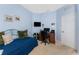 Bedroom with blue walls featuring a window, desk, and a twin day bed at 13392 Abercrombie Dr, Englewood, FL 34223