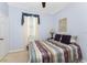 Cozy bedroom with blue walls, a striped comforter, and a window with light-filtering blinds at 13392 Abercrombie Dr, Englewood, FL 34223