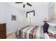 Cozy bedroom featuring a ceiling fan, neutral walls, and a striped bedspread at 13392 Abercrombie Dr, Englewood, FL 34223