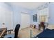 Bedroom with blue walls featuring a window, closet, and a twin day bed at 13392 Abercrombie Dr, Englewood, FL 34223