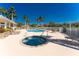 Community pool and hot tub surrounded by lounge chairs and manicured landscaping at 13392 Abercrombie Dr, Englewood, FL 34223