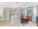 Dining room area with tile floors and view into the living room at 13392 Abercrombie Dr, Englewood, FL 34223