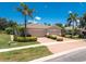 Beautiful single-story home featuring a paved driveway, lush landscaping, and a two-car garage at 13392 Abercrombie Dr, Englewood, FL 34223
