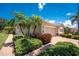 Beautiful single-story home featuring a two car garage, complemented by lush landscaping and well-maintained plants at 13392 Abercrombie Dr, Englewood, FL 34223